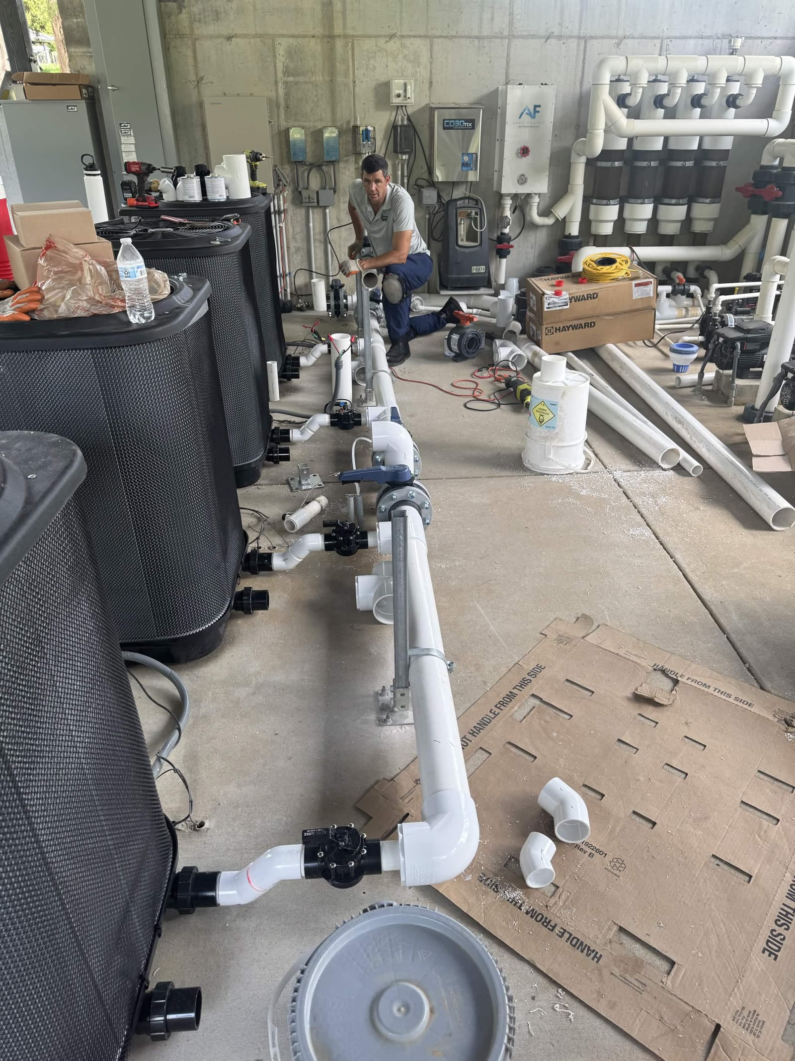 Passion Pool Care technician rebuilding pool pump, filter and PVC plumbing