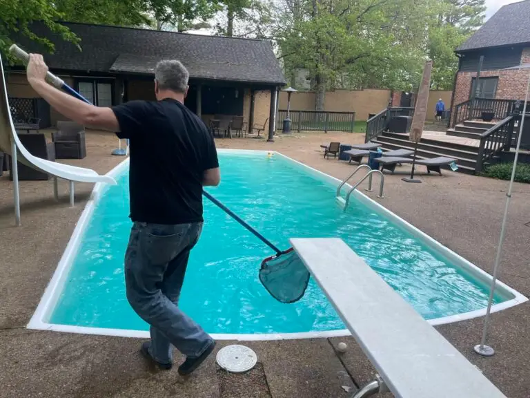 Passion Pool Care technician skimming a pool during weekly pool cleaning