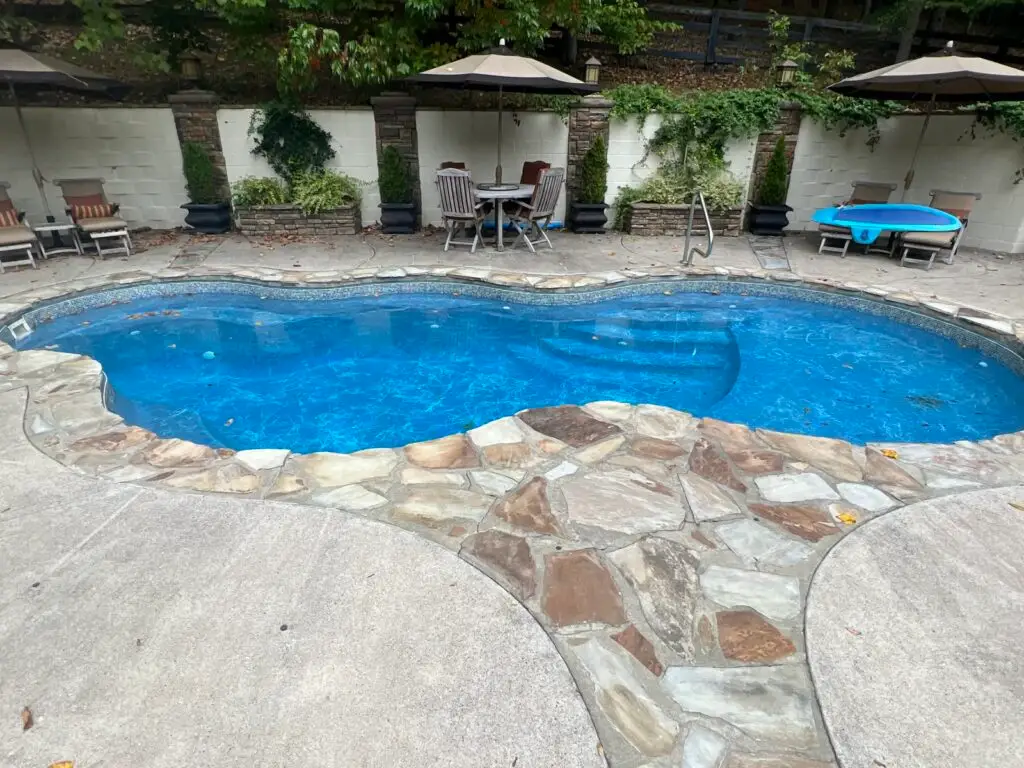 Clean blue inground pool with balanced water and countryside view