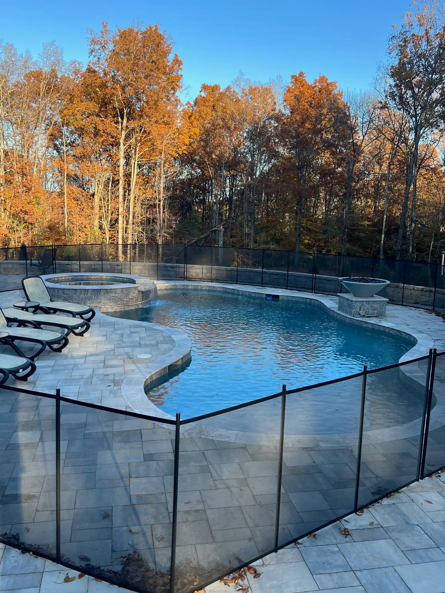 Restored crystal-clear kidney-shaped pool with spa