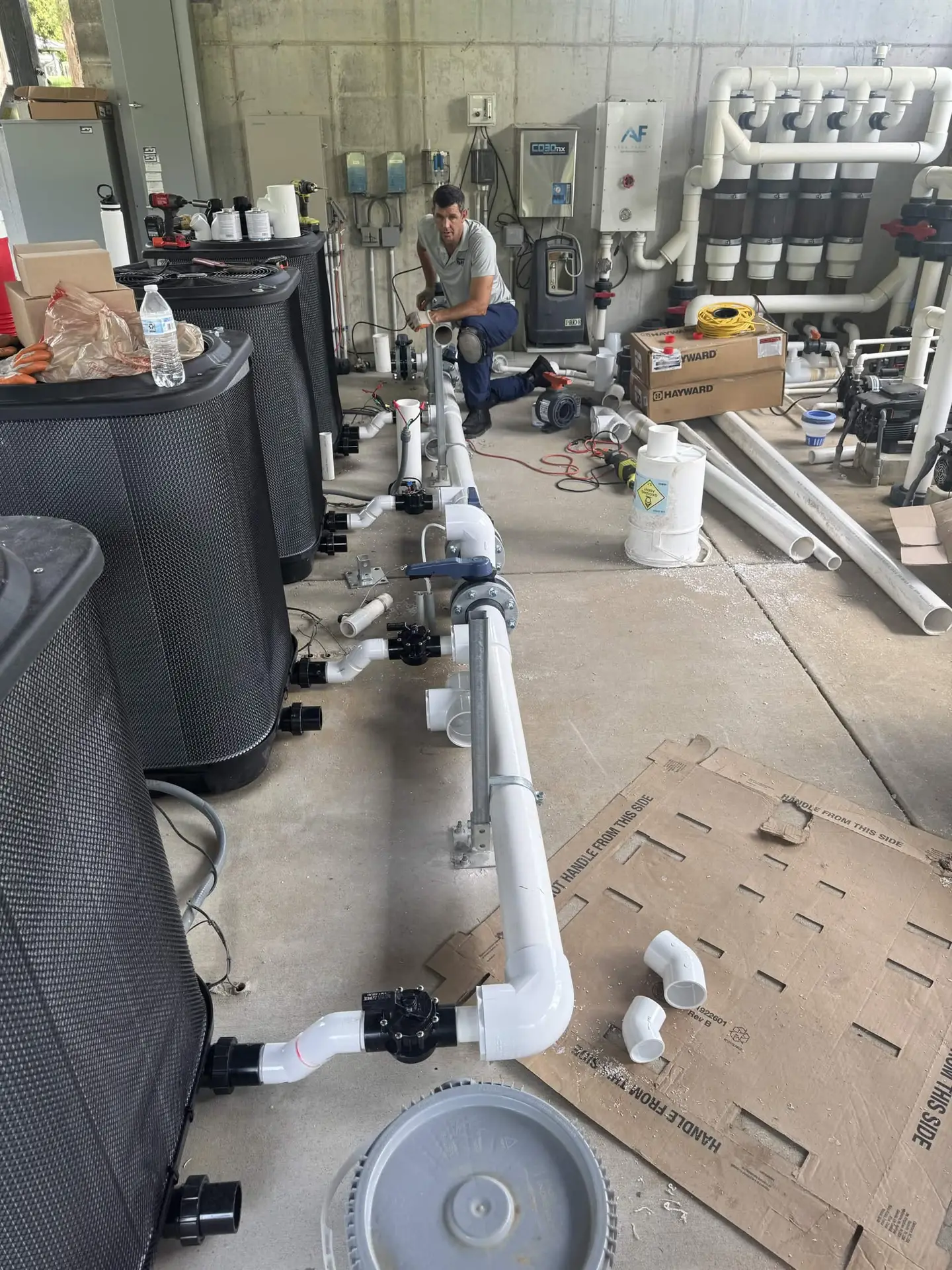 Passion Pool Care technician rebuilding pool pump, filter and PVC plumbing